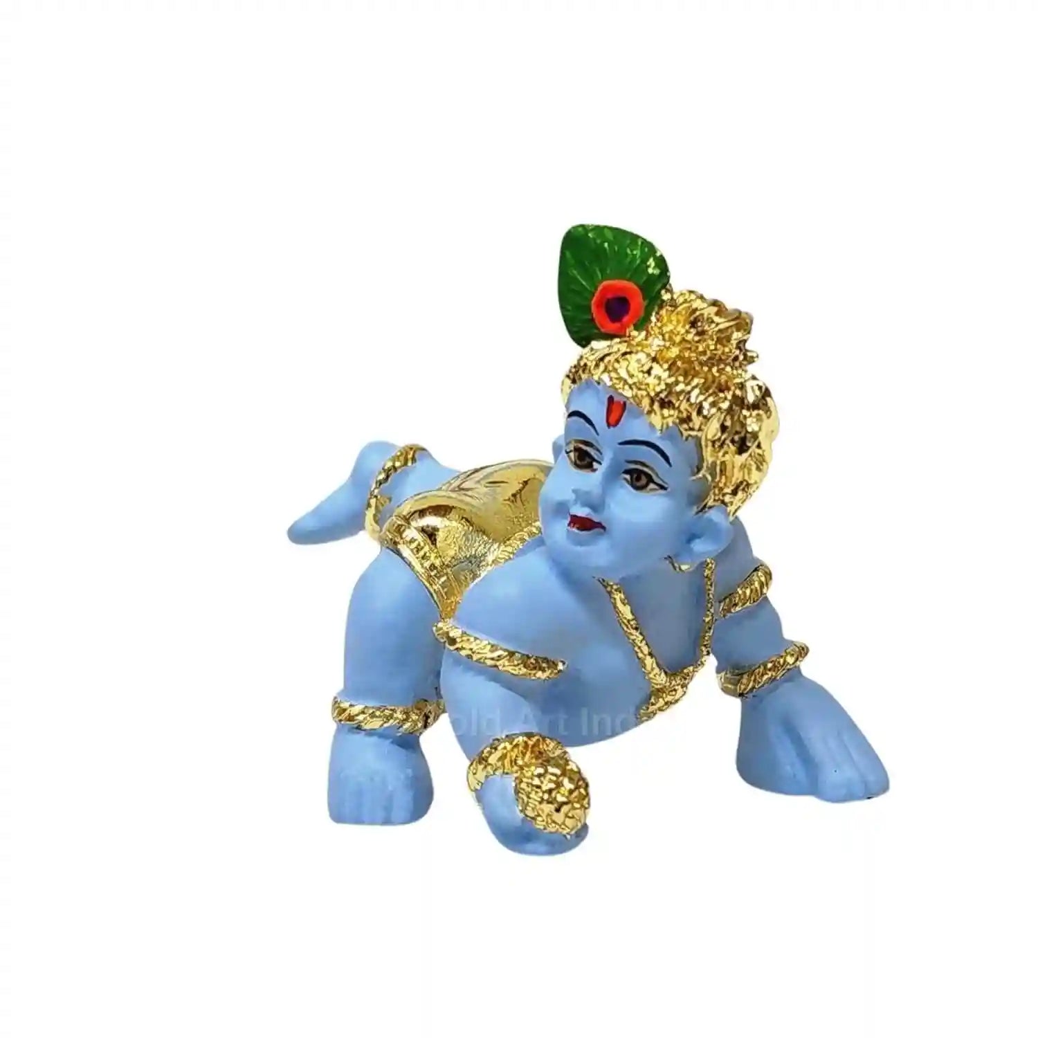 A small blue idol of baby Krishna crawling, adorned with Gold Plated and a peacock feather on his head. The idol is placed in front of a large peacock feather.