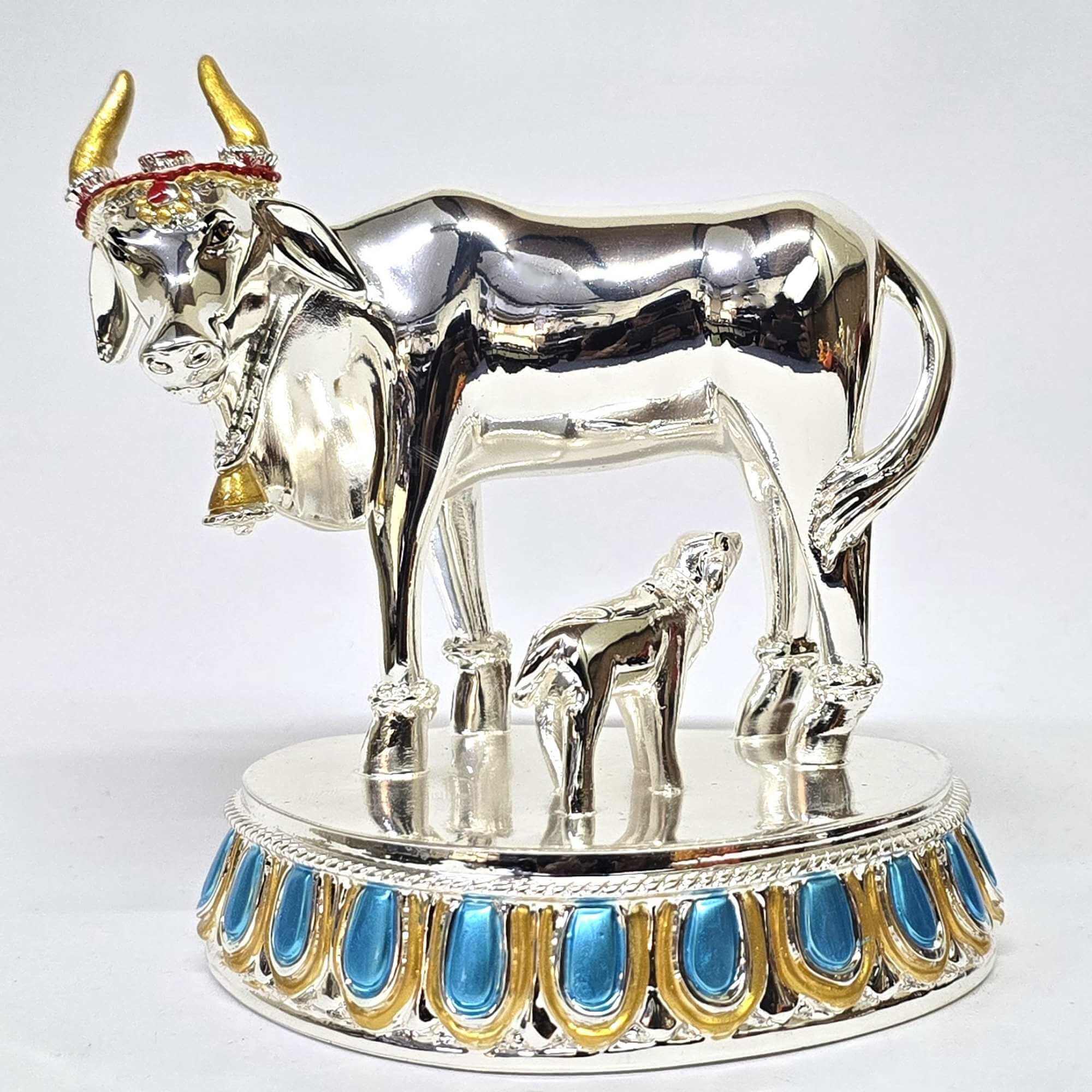 Elegant silver Plated Kamadhenu cow and calf idol with intricate detailing, symbolizing prosperity and spiritual blessings. Perfect for home decor, puja rituals, and gifting