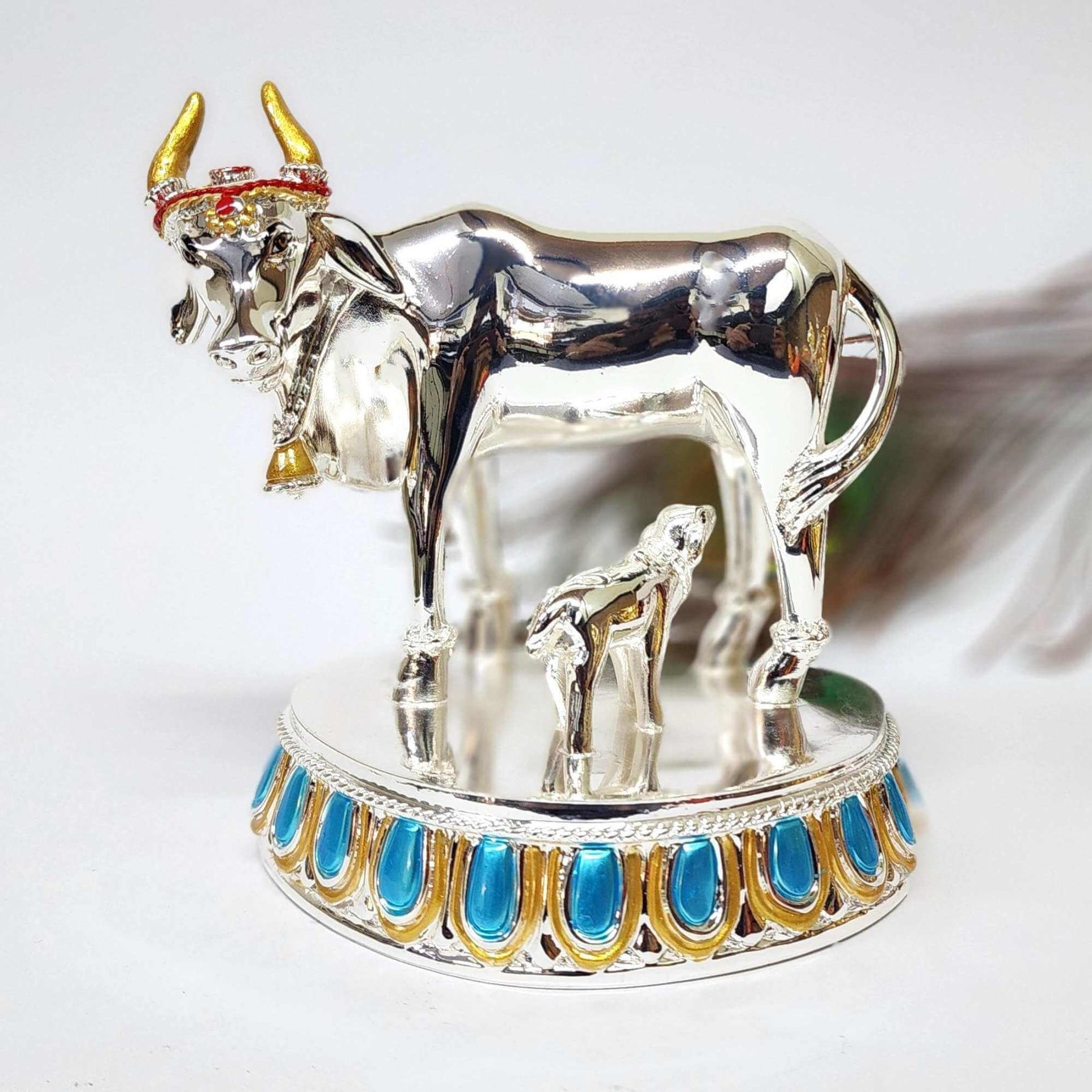 Elegant silver Plated Kamadhenu cow and calf idol with intricate detailing, symbolizing prosperity and spiritual blessings. Perfect for home decor, puja rituals, and gifting
