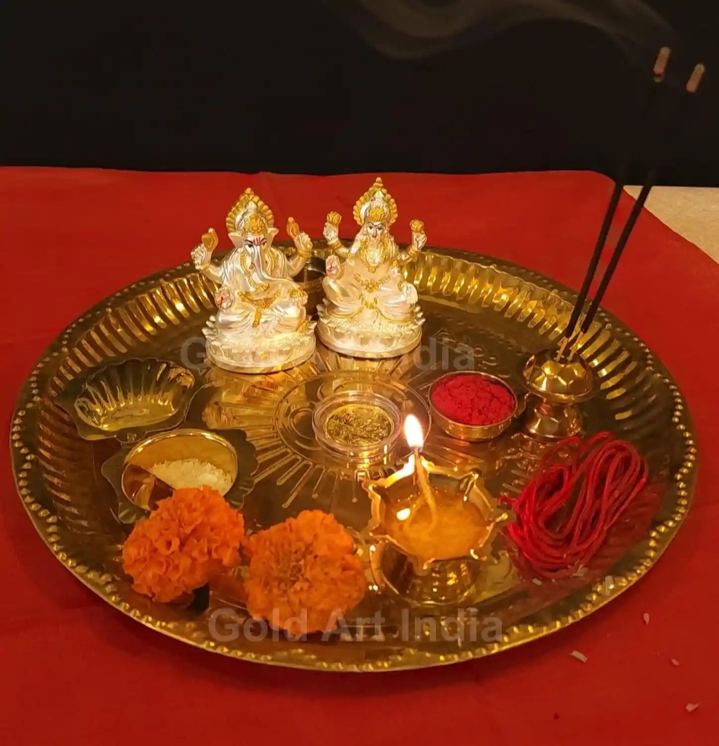 Silver-Plated Lakshmi and Ganesha Idol Set with golden coin, placed on festive lighting background for pooja décor