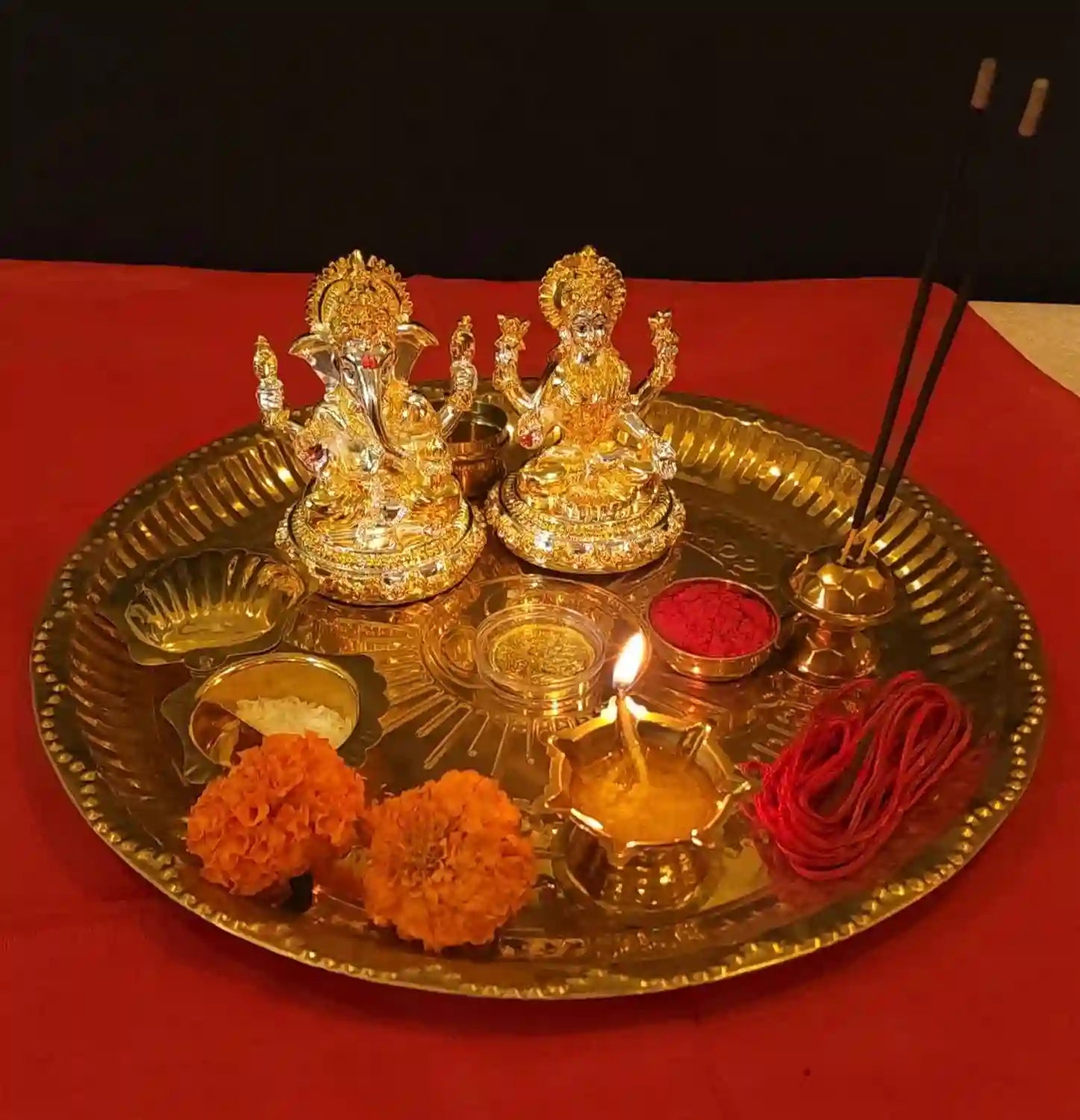 Gold & Silver Plated Lakshmi Ganesh Idol set with gold-plated coin, showcased in festive pooja setup with diyas 