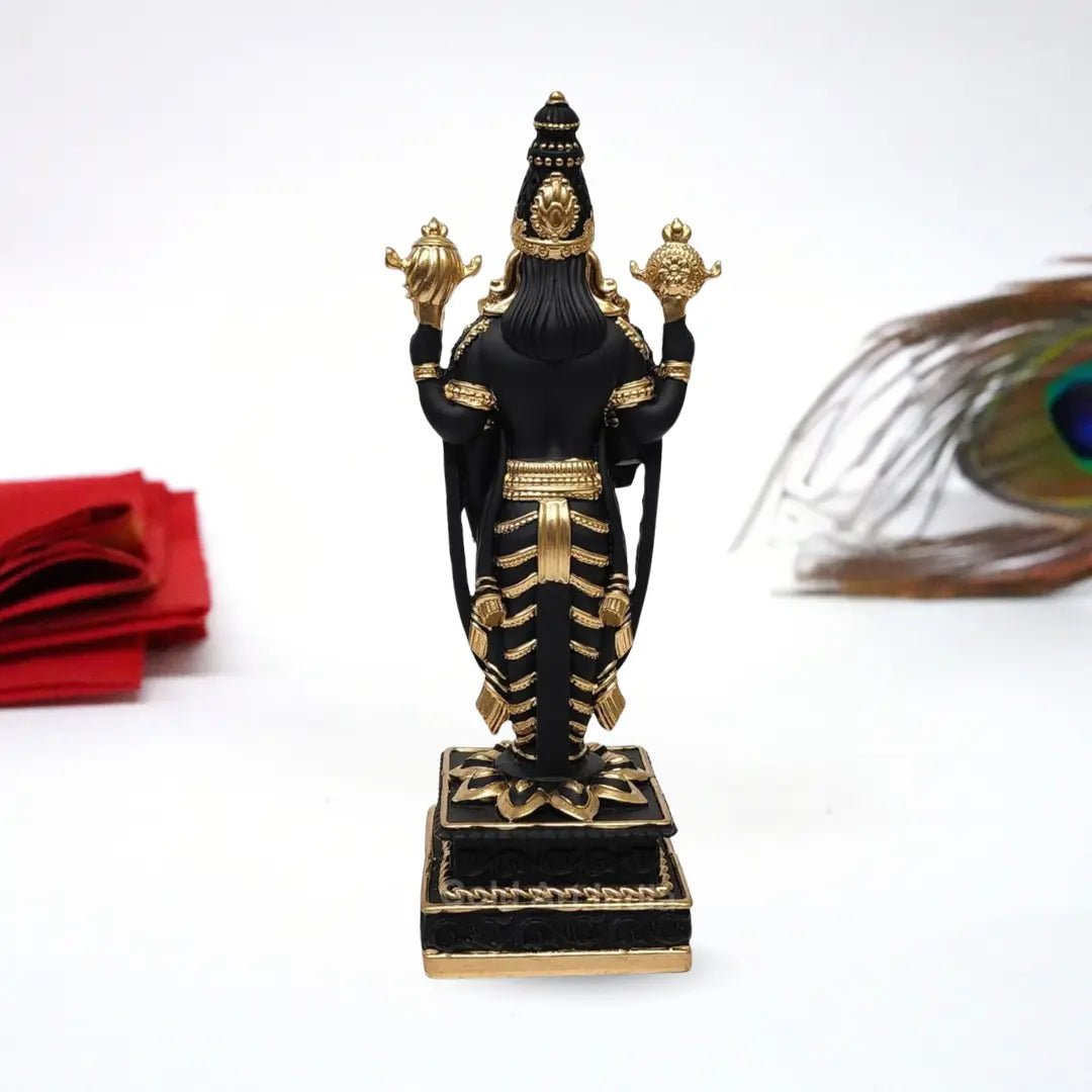 Black and gold  Plated Lord Venkateshwara idol, intricately detailed with ornate jewelry and traditional symbols, standing on a decorated pedestal.