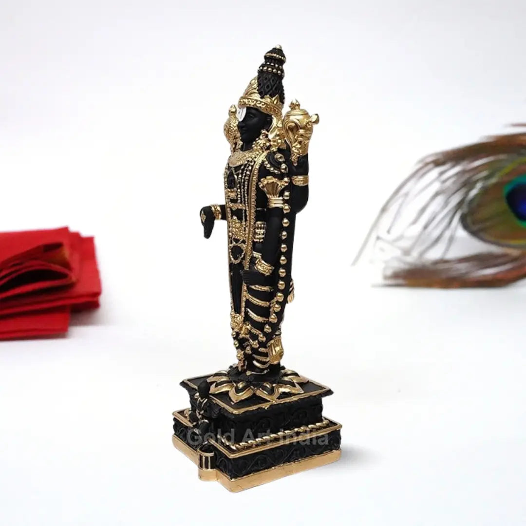Black and gold  Plated Lord Venkateshwara idol, intricately detailed with ornate jewelry and traditional symbols, standing on a decorated pedestal.