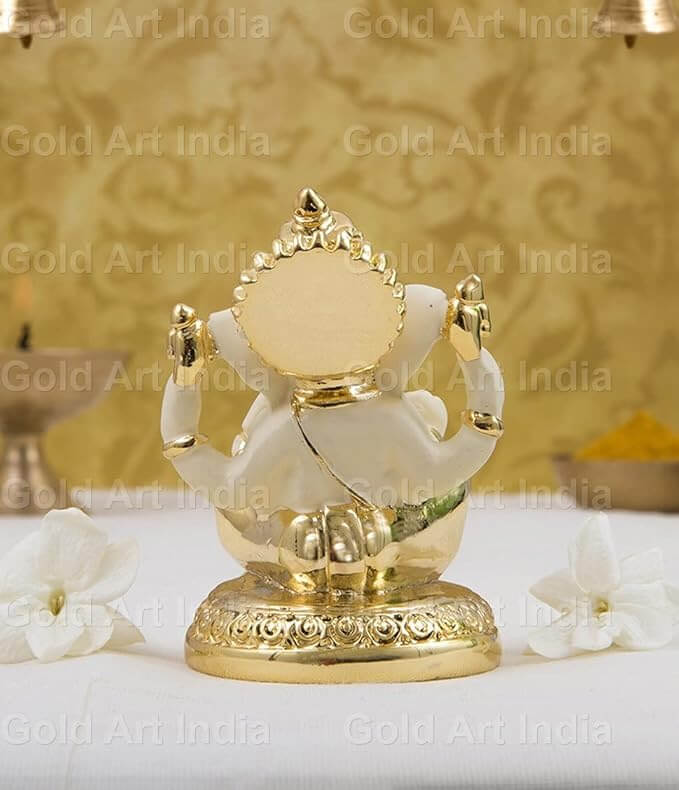 Gold plated off-white terracotta Ganesha idol, perfect for home and office decor, measuring 3x2 inches.