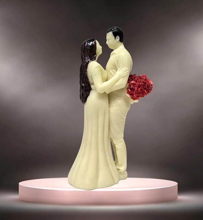 Ivory romantic couple figurine by Gold Art India, hand-painted with vibrant red flowers, symbolizing love and affection.