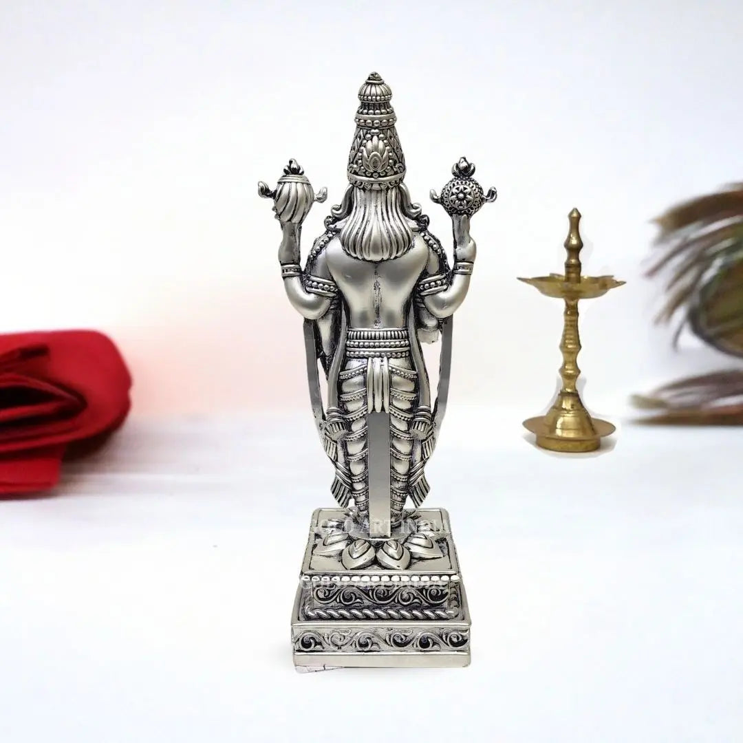 Angled view of silver-plated Tirupati Balaji idol with detailed jewelry and matte body