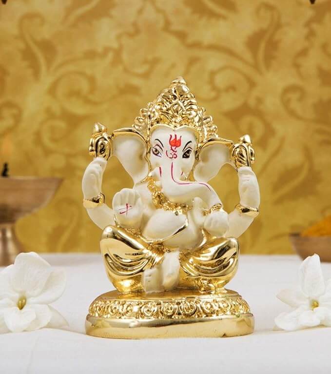 Gold plated Ganesha idol with off-white finish, perfect for home and office decor, measuring 3x2 inches.