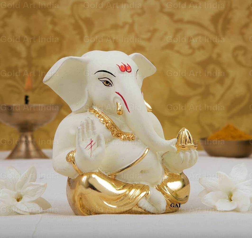 Gold plated off white terracotta Ganesha idol, 2 inches, perfect for home, office decor, and festive gifts.
