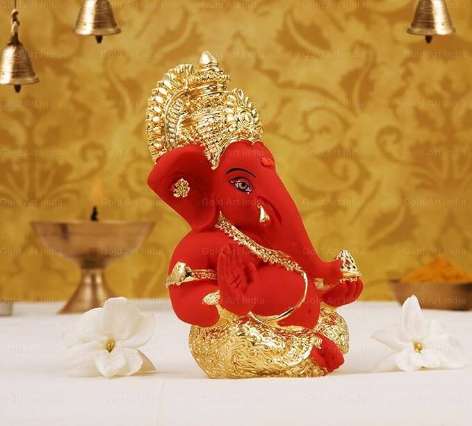 Gold plated orange Ganesha idol, perfect for home and car decor, 3.5 inches high, perfect gift for festivals.