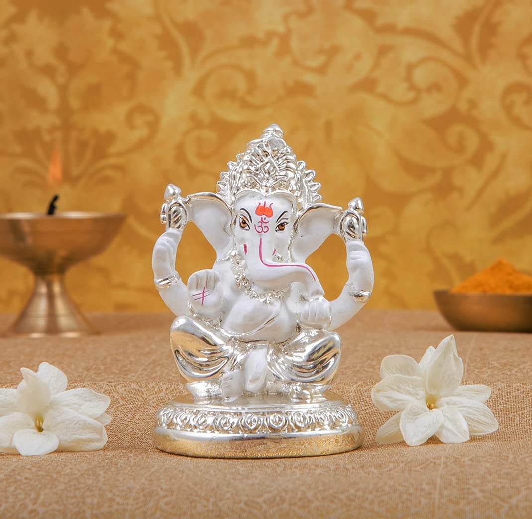 Silver plated Ganesha idol on round base, ideal for office, home decor, and gifting for various occasions.