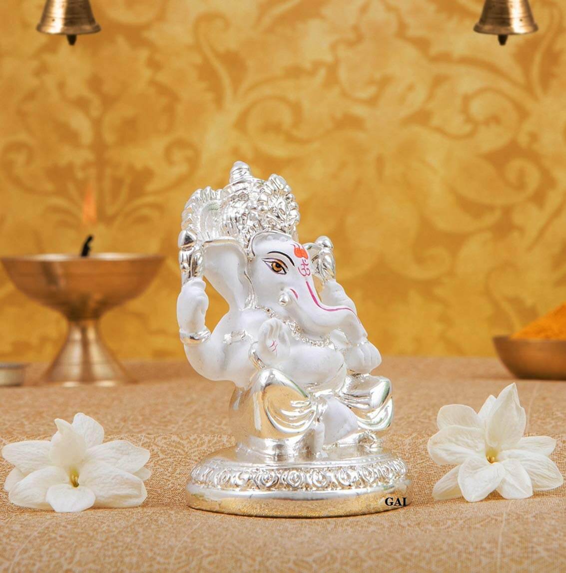 Silver plated Ganesha idol on round base, perfect for home and office decor, featuring high-quality ceramic finish.