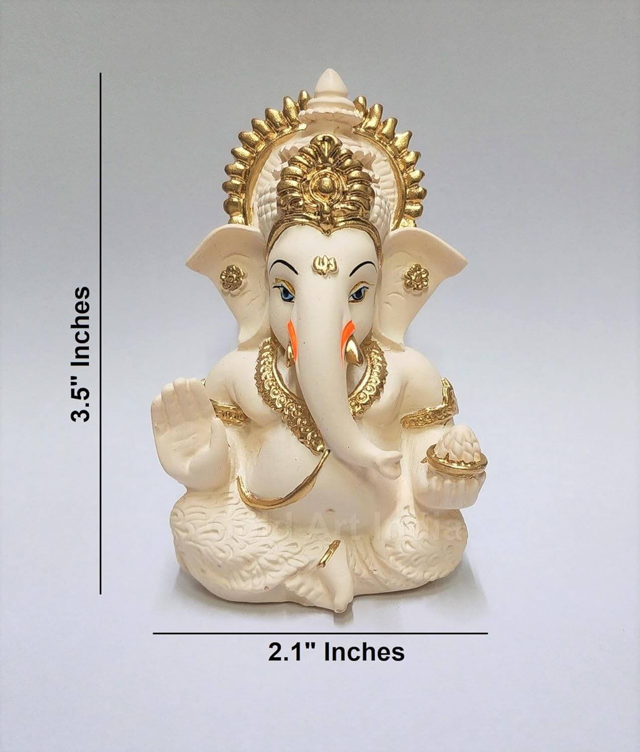 Peach ivory Lord Ganesha idol with intricate gold detailing, seated in a blessing posture, holding a modak in one hand.dimension H3.5 x W2.1